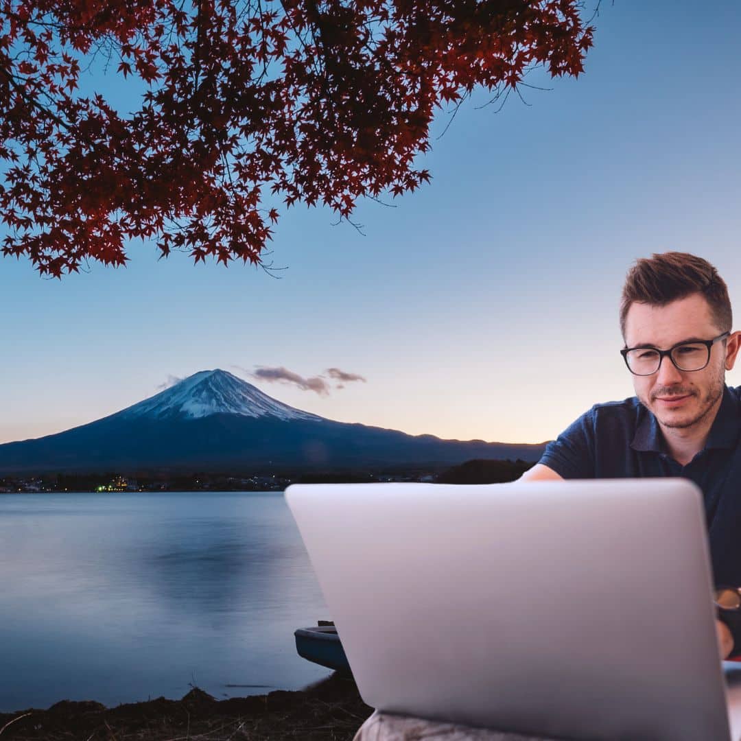 A digital nomad working on his computer near Mt. Fuji Japan
